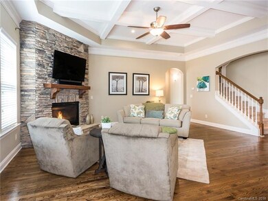 Gorgeous stone fireplace and coffered ceiling