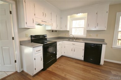 Kitchen featuring premium range hood, white cabine