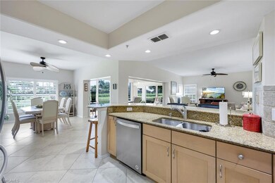 Kitchen with dishwasher, ceiling fan, light stone counters, open floor plan, and light brown cabinets