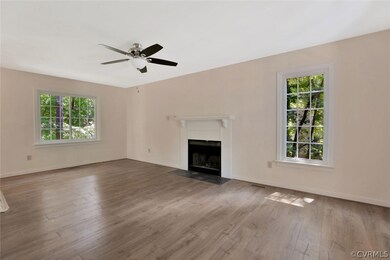 Large living room has new flooring and neutral pai