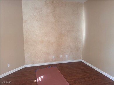 Unfurnished room with dark wood-style floors and b
