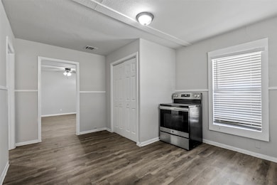 Kitchen featuring a ceiling fan, dark wood-style f