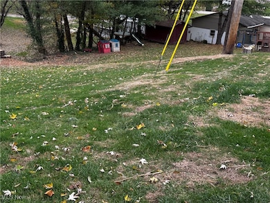 View of grassy yard with a playground