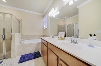 Full bath with double vanity, tile patterned floor