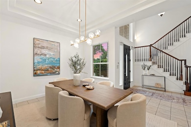 Dining space with stairway, light tile patterned 
