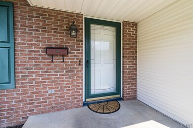 The central covered entry has brick accents accent
