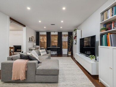 Living room featuring dark wood-style flooring, r