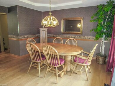 Formal dining room with a tray ceiling.