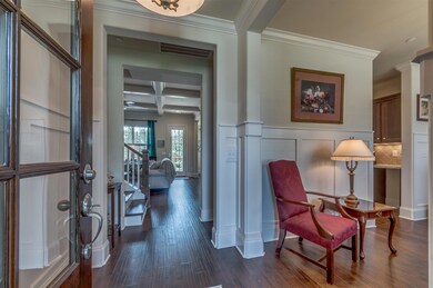 Beautiful formal dining with custom wains coating off entry foyer. 