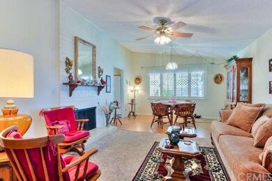 The living/dining area has a cozy fireplace and 2 