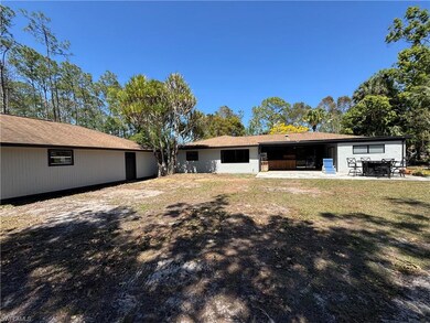 Rear view of property with a yard and a patio area