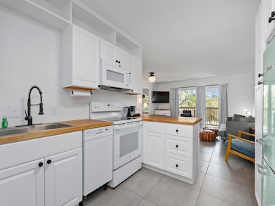 Kitchen featuring a sink, a peninsula, open floor 