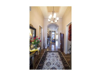 Grand entrance with archways, hardwood floors & tr