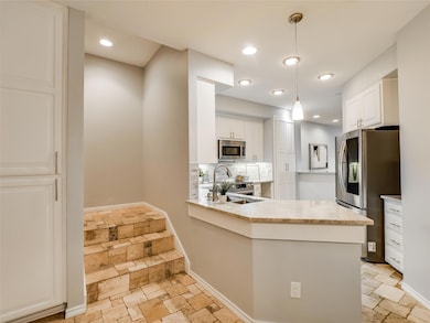 Kitchen with decorative backsplash, white cabinet