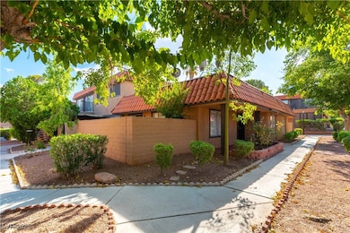 View of side of property featuring stucco siding and a tiled roof