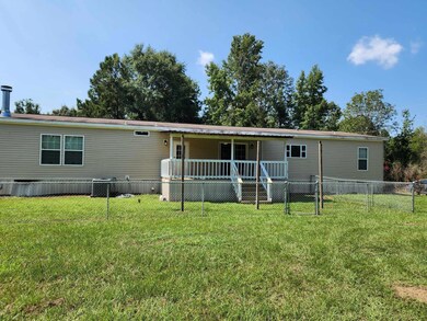 Back of house with a lawn
