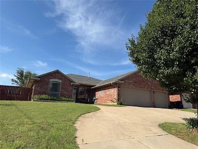 Ranch-style house with brick siding, an attached garage, driveway, and roof with shingles