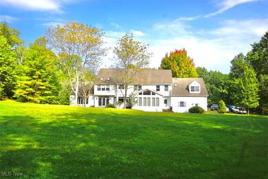 Rear view of property featuring a spacious yard.