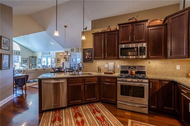 Designer cook's kitchen featuring stainless steel appliances with view of great room - cathedral ceilings!