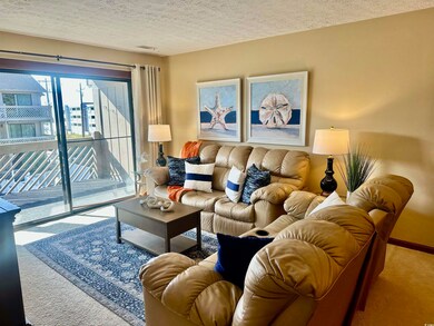 Living area with visible vents, carpet floors, and