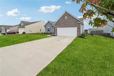 View of front of house with brick siding, concrete driveway, and a garage
