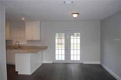 Dining area with french doors that open to pool ar