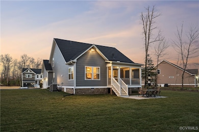 Rear view of house with a yard, crawl space, a pat