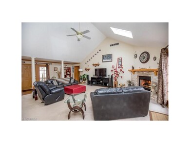 Great room with stately white pillars, vaulted cei