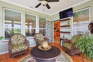 Sunroom / solarium featuring ceiling fan