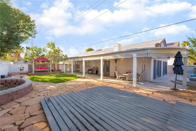 Back of house featuring a patio area, a gazebo, stucco siding, and a chimney