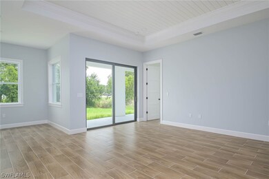 Empty room with light wood-type flooring and a tra