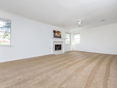 Unfurnished living room featuring crown molding, 