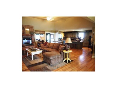 Large open kitchen on living room with fireplace.