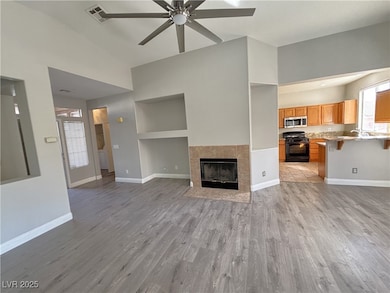 Unfurnished living room with ceiling fan, light wo