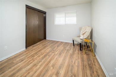 Sitting room featuring light wood finished floors and baseboards