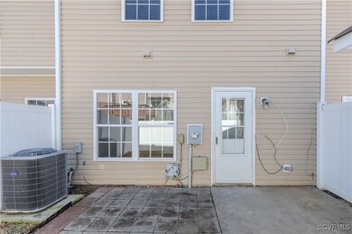 Doorway to property with a patio and central AC
