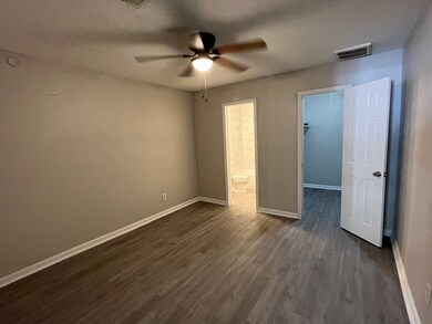 Room with walk in closet and bathroom