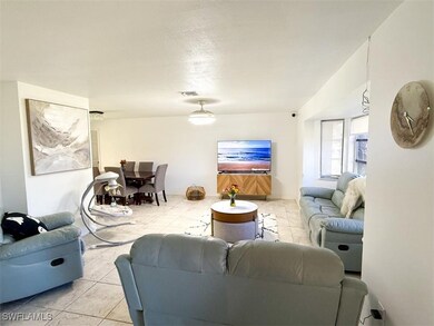 Living room with visible vents and light tile patt