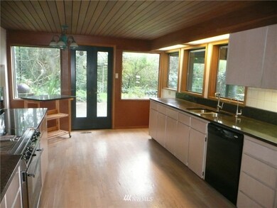 Kitchen with moveable counter and space for informal eating. Your outside enjoyment is just through the doors.