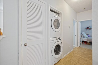 Laundry area with stacked washing machine and dry