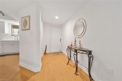 Hallway featuring light wood-style flooring and recessed lighting