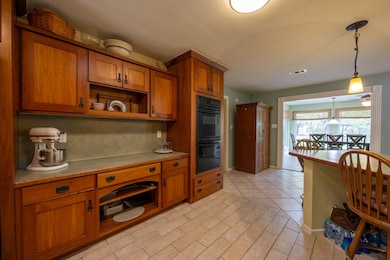 Reverse side of the kitchen showcasing more storage and double ovens.