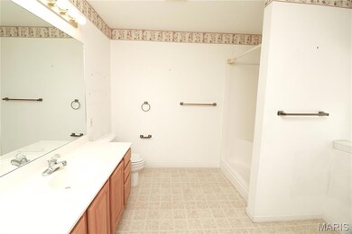 Full bathroom with vanity and light floors