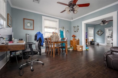 Office area featuring visible vents, crown molding
