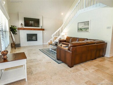The light, bright family room has a wood-burning f