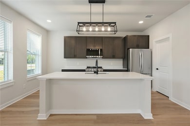Kitchen with stainless steel microwave, a sink, da