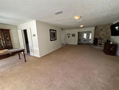 Unfurnished living room featuring a fireplace, lig