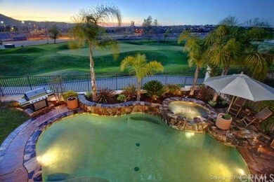 Pool and golf course view from deck at twilight