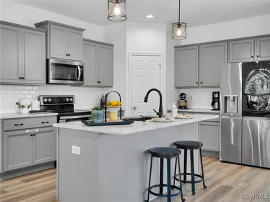 Kitchen with an island with sink, light hardwood /