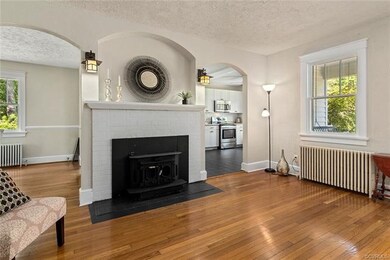 Original hardwood floors, brick manteled fireplace